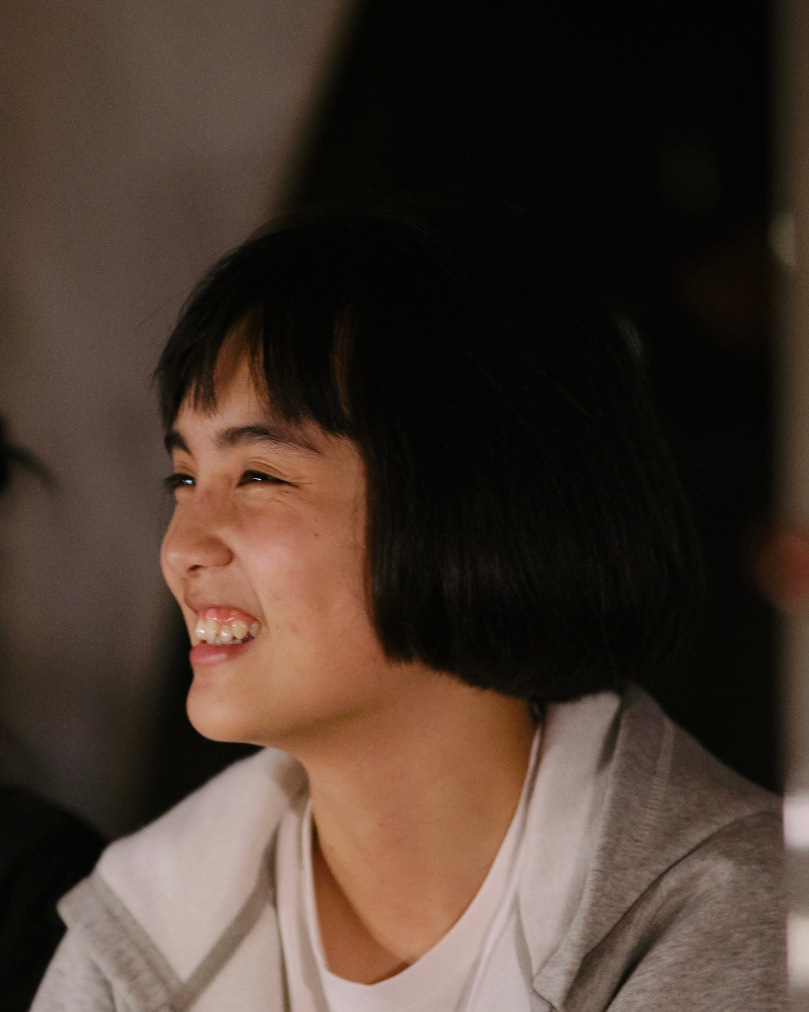 Tram Le smiling in a candid portrait